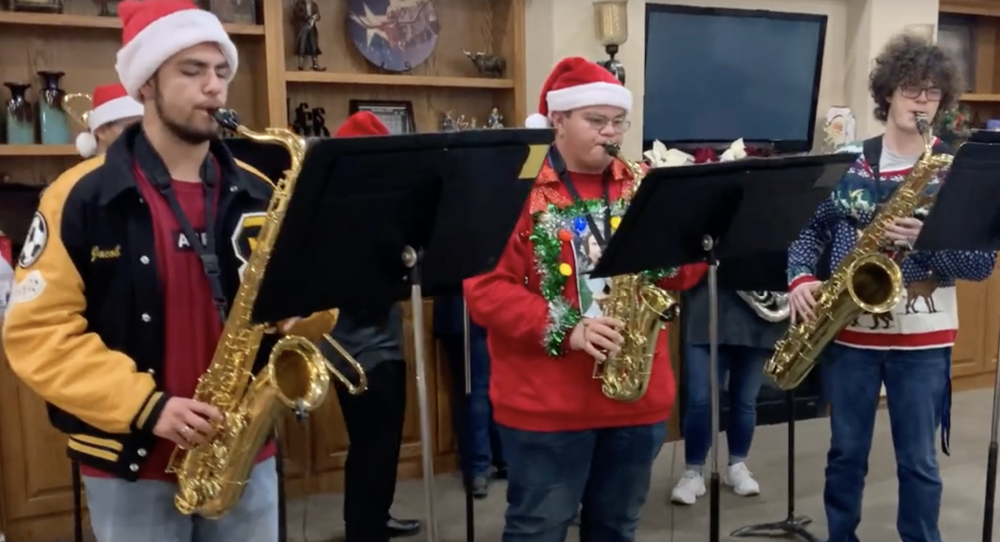 photo of students playing instruments in festive attire 