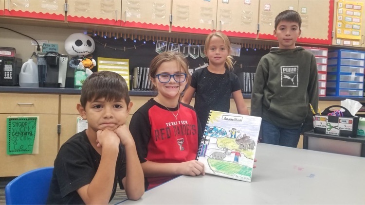 students show off their magic tree house book 