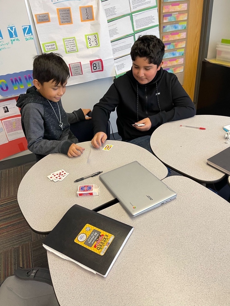 students playing cards to work in math facts 