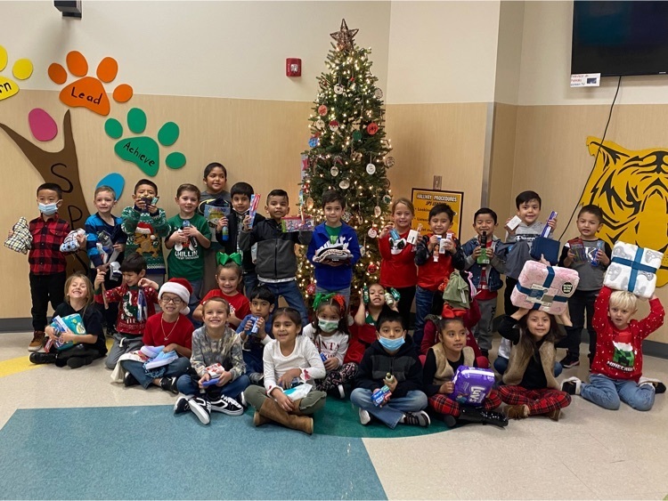 students pose with donations 