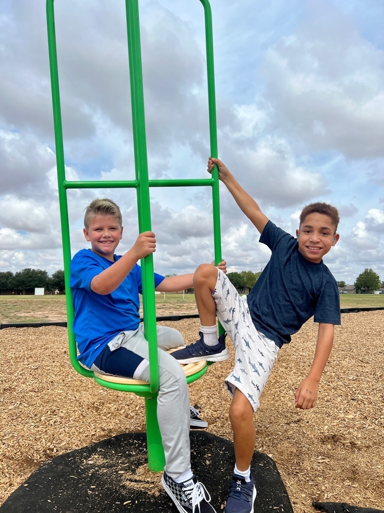 two boys playing on playground 