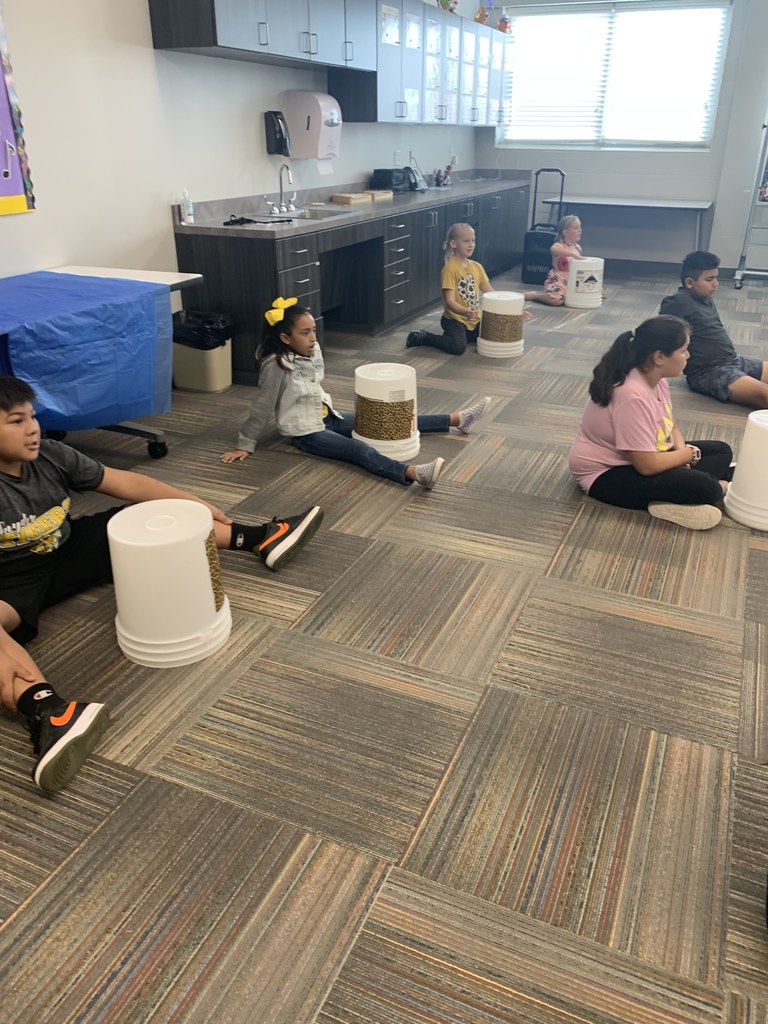students playing bucket drums