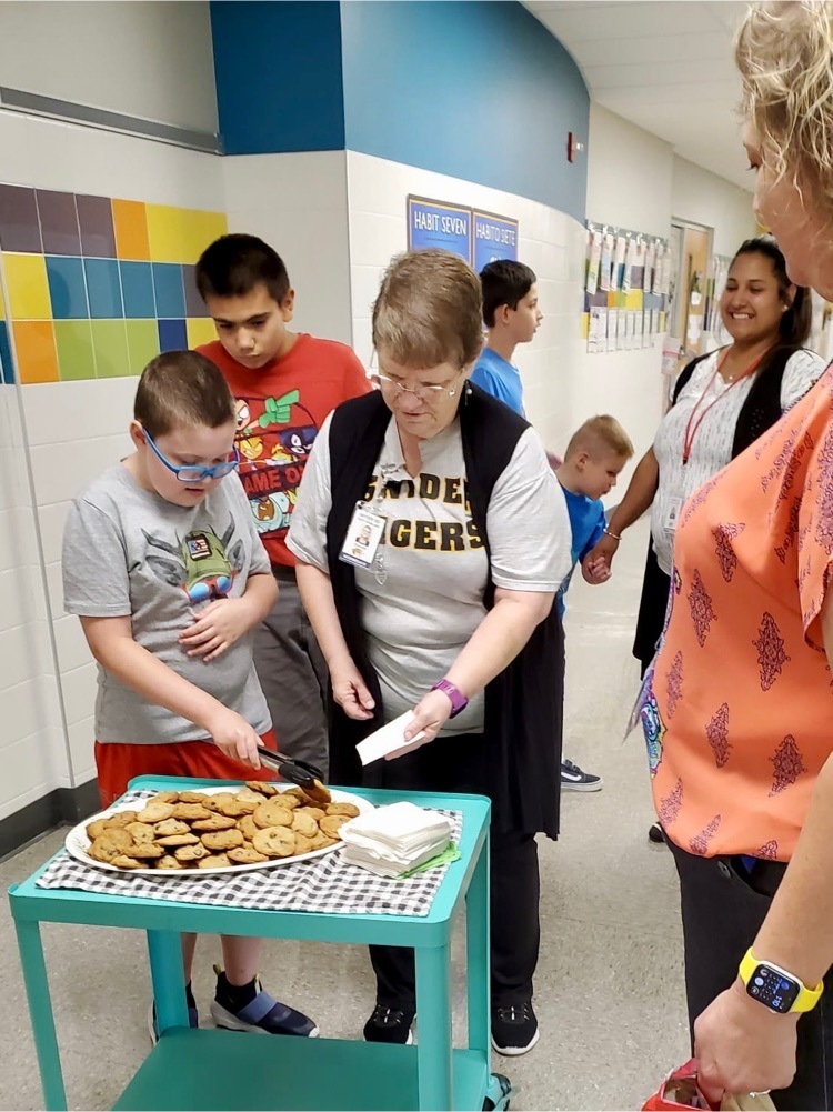 students baking and serving cookies 