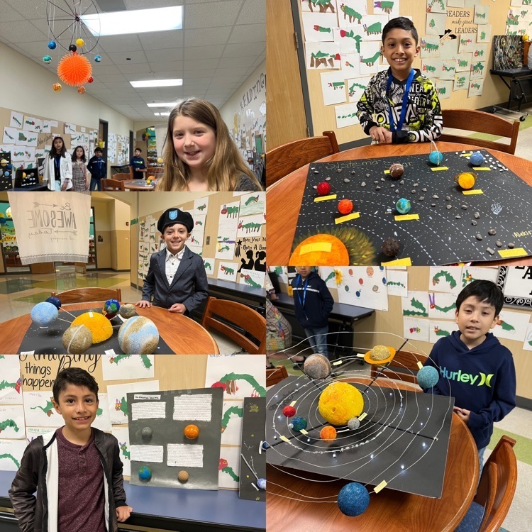 students posing with solar system projects