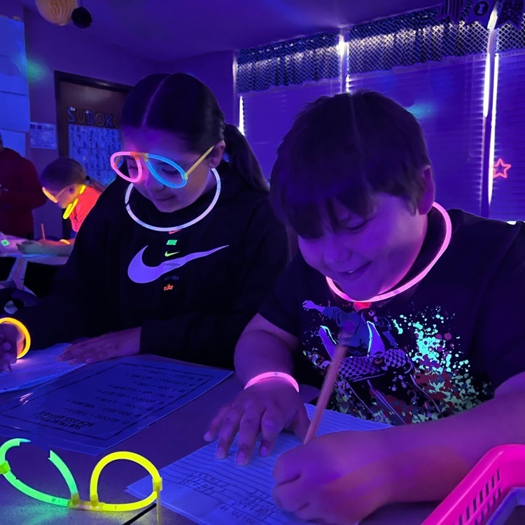 students wearing neon clothing and glow in the dark necklaces 