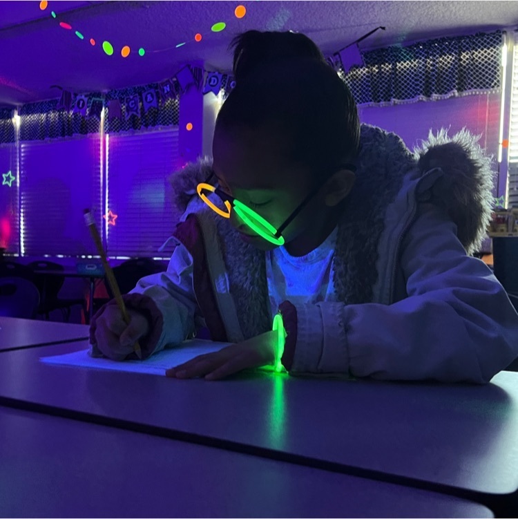 students wearing neon clothing and glow in the dark necklaces 